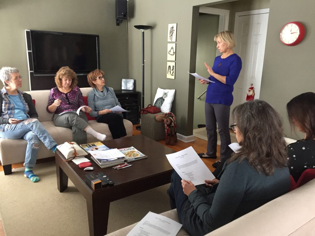 Photo of Sylva teaching a workshop to a group of women.